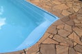 Detail of blue swimming pool and stone floor Royalty Free Stock Photo