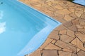 Detail of blue swimming pool and stone floor Royalty Free Stock Photo