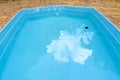 Detail of blue swimming pool and stone floor Royalty Free Stock Photo