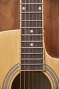 Detail of the body of a light wood guitar, soundhole, fretboards and strings Royalty Free Stock Photo
