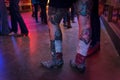 Detail of the boots and tattoed legs of a young woman in the Broken Spoke dance hall in Austin, Texas