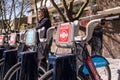 Detail of Boris bikes in line with woman in the background.