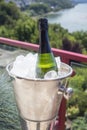 Detail of bottle of champagne in an ice bucket outdoors on a sunny day Royalty Free Stock Photo