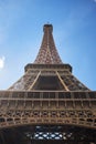 Detail bottom view of Eiffel Tower on the blue sky background in sunset light