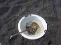 Detail of bowl and scoop in Volcanic sand in Santorini Royalty Free Stock Photo