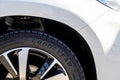 The detail of a brand new GoodYear tyre on a white Peugeot SUV