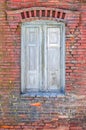 Detail of a brick wall with closed window Royalty Free Stock Photo