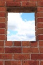 Window in red brick wall view to sky