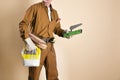 Detail of bricklayer holding tools and building materials Royalty Free Stock Photo