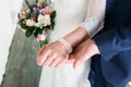 Detail of bride`s bouquet and hands holding Royalty Free Stock Photo