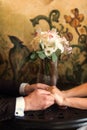 Detail of bride`s roses bouquet and hands holding Royalty Free Stock Photo