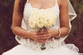 Detail of bride's roses bouquet and hands holding Royalty Free Stock Photo