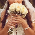 Detail of bride's roses bouquet and hands holding Royalty Free Stock Photo