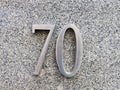 Stainless Steel Street Sign, Number 70, on Granite Wall