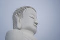 Detail of Buddha head marble statue in a Buddhist temple and blue sky background in Danang, Vietnam