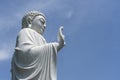 Detail of Buddha marble statue in a Buddhist temple and blue sky background in Danang, Vietnam. Closeup, copy space