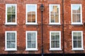 Detail of a building with street lamp and typical English windows. Royalty Free Stock Photo