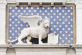 Detail of a building in Venice where a winged lion appears holding a book Royalty Free Stock Photo