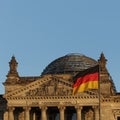 Detail of the Bundestag or Reichstag building, seat of the German Parliament, with German flag Royalty Free Stock Photo