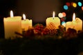 Detail of burning candles with background made of colorful bokeh lights