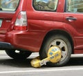 Detail of a car immobilized by a clamp in New York City. Royalty Free Stock Photo