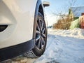 Detail of car tires in winter on the road covered with snow. Royalty Free Stock Photo