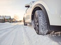 Detail of car tires in winter on the road covered with snow. Royalty Free Stock Photo