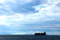 Detail of a cargo ship breezing through the Tyrrhenian sea teeming with clouds Royalty Free Stock Photo