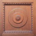 Detail of carved brown wooden door with ornament