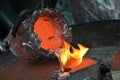 Casting liquid aluminium from crucible into sand form