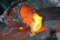 Casting liquid aluminium from crucible into sand form