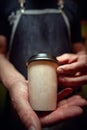 Detail of Caucasian man holding coffee in cardboard cup