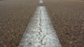 central white line of a road painted on the asphalt