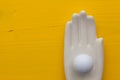 Detail of ceramic hand with golf equipments