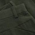 Detail of a checkered dark green trouser belt with loop and pocket