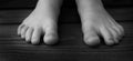 Bare Feet of Child Black and White on Wood Grain Steps for Innocence and Purity Royalty Free Stock Photo