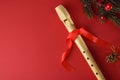 Detail of traditional plastic recorder on red with Christmas decoration