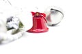 Detail of Christmas decoration, red bell and gray ball on white background. Royalty Free Stock Photo