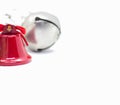 Detail of Christmas decoration, red bell and gray ball on white background. Royalty Free Stock Photo