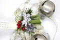 Detail of Christmas decoration with white ribbon and gold details. Silver angel christmas decoration with green details and red be Royalty Free Stock Photo