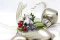 Detail of Christmas decoration with white ribbon and gold details. Silver angel christmas decoration with green details and red be Royalty Free Stock Photo