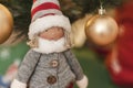 Detail of christmas doll with background of christmas decorations and christmas lights Royalty Free Stock Photo