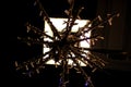 Detail Christmas snowflake decoration with street lamp lights.