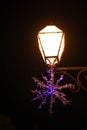 Detail Christmas snowflake decoration with street lamp lights. Royalty Free Stock Photo