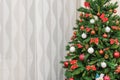 Detail of a Christmas tree against a textured curtain
