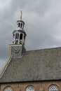 Detail of church in Ottoland, tower and clock against cloudy sky