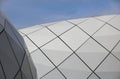 Detail of a circular facade of a modern building made of sandwich panels on blue sky background. Royalty Free Stock Photo