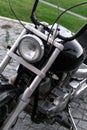 Detail of classic black chopper motorcycle front headlight and chrome fork Royalty Free Stock Photo