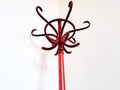 Detail of classic red hanger with white wall in background. House equipment Royalty Free Stock Photo