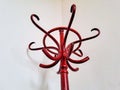 Detail of classic red hanger with white wall in background. House equipment Royalty Free Stock Photo